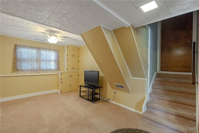 additional living space with light colored carpet and ceiling fan