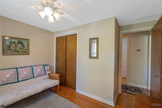 living room featuring light wood-type flooring and ceiling fan