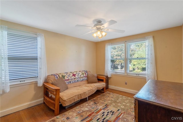 living room with light wood-type flooring and ceiling fan