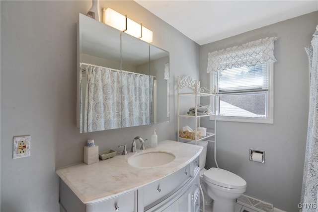 bathroom with vanity and toilet