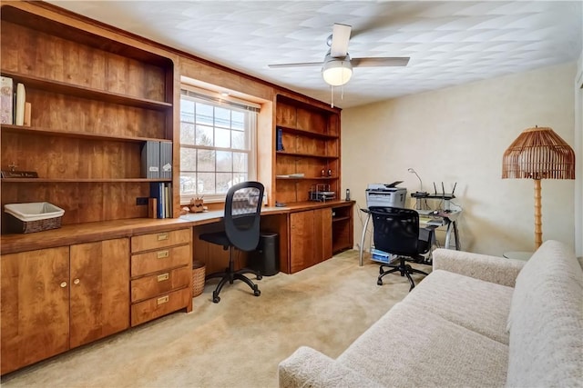 office space featuring ceiling fan and light colored carpet