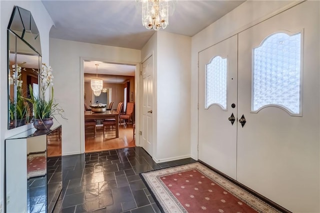 entryway with a chandelier and french doors