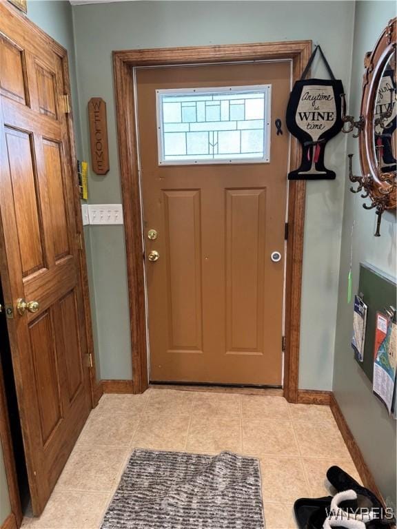 entrance foyer with light tile patterned flooring and baseboards