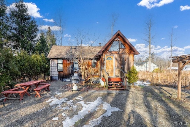 exterior space with roof with shingles