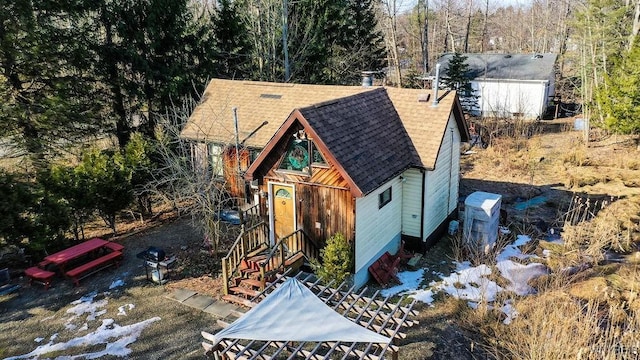 view of front of house featuring roof with shingles