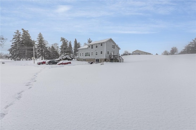 view of snow covered rear of property