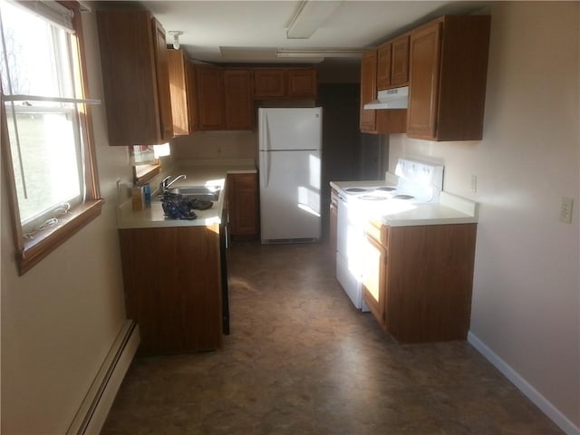 kitchen featuring white appliances, baseboard heating, and sink