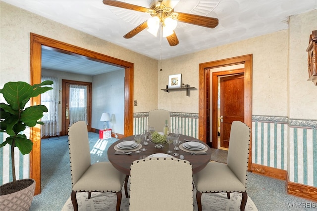 dining area featuring ceiling fan and carpet