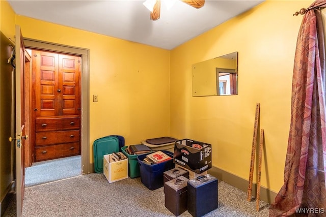 interior space with ceiling fan