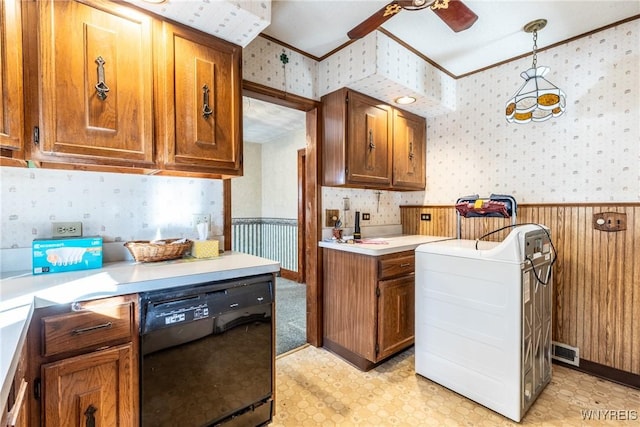 kitchen featuring hanging light fixtures, black dishwasher, ceiling fan, washer / dryer, and crown molding