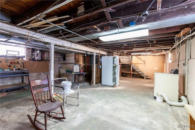 basement with heating unit and washer / dryer