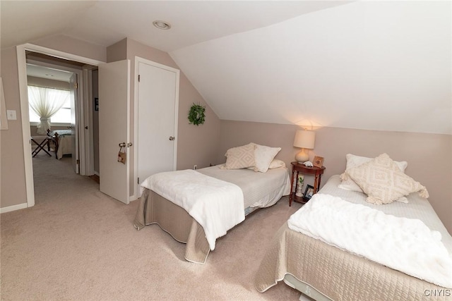 bedroom featuring lofted ceiling and light colored carpet