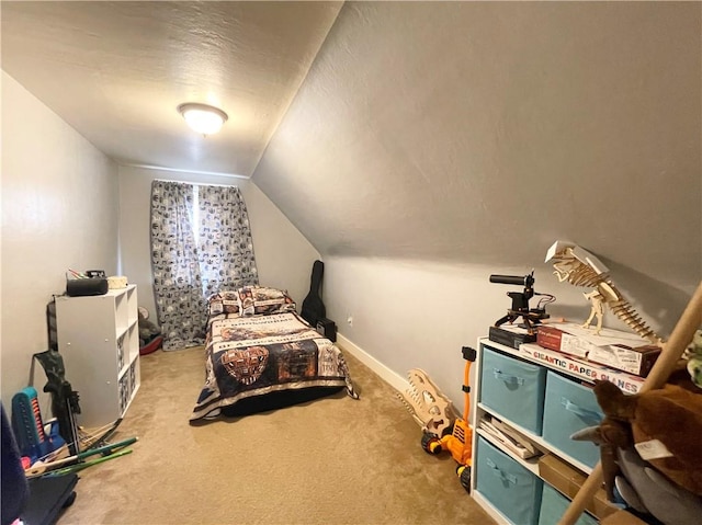 carpeted bedroom featuring lofted ceiling