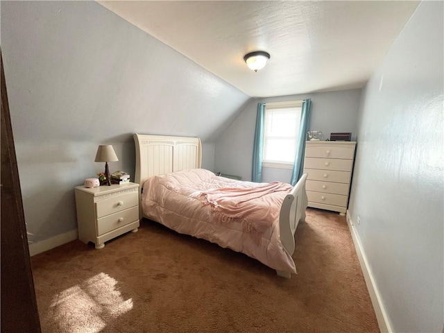 bedroom with dark carpet and lofted ceiling