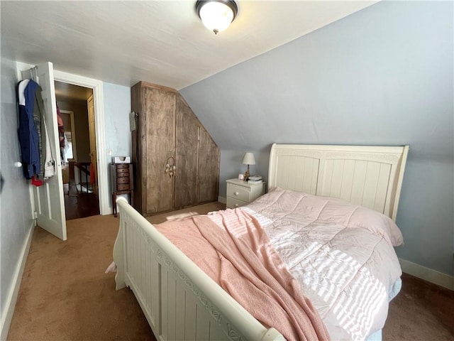 carpeted bedroom featuring vaulted ceiling