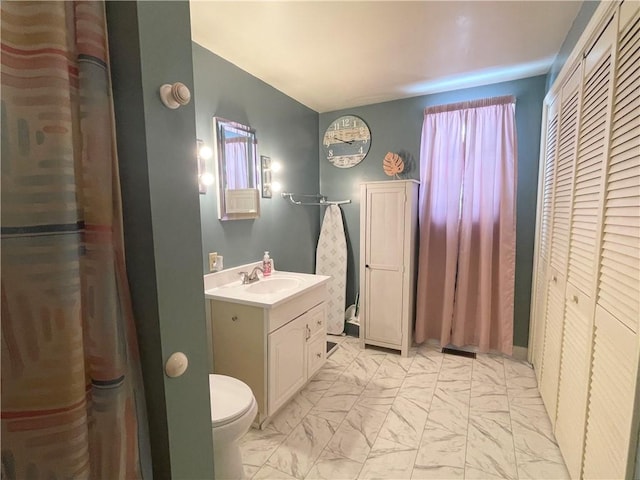 bathroom featuring toilet and vanity