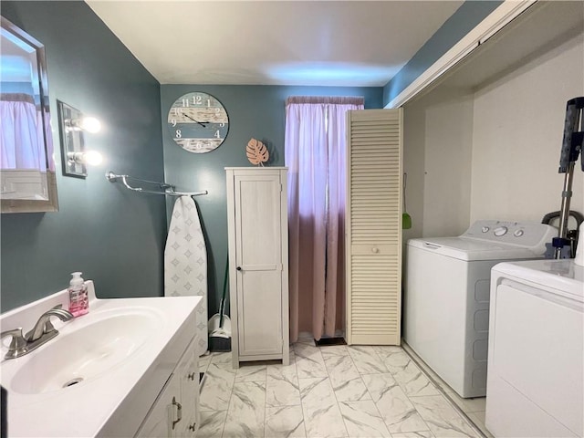 bathroom featuring washer and clothes dryer and sink