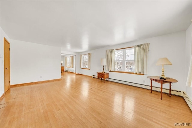 unfurnished living room with light wood-type flooring and a baseboard radiator