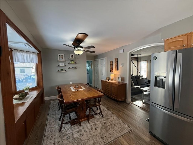 dining space featuring ceiling fan and dark wood-type flooring