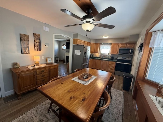 kitchen featuring ceiling fan, sink, dark wood-type flooring, and stainless steel appliances