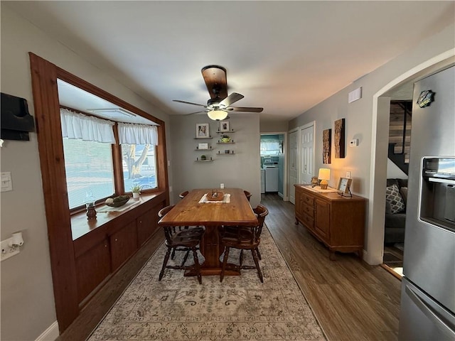 dining area featuring ceiling fan and dark hardwood / wood-style flooring