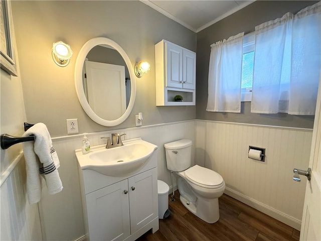 bathroom with crown molding, wood-type flooring, vanity, and toilet