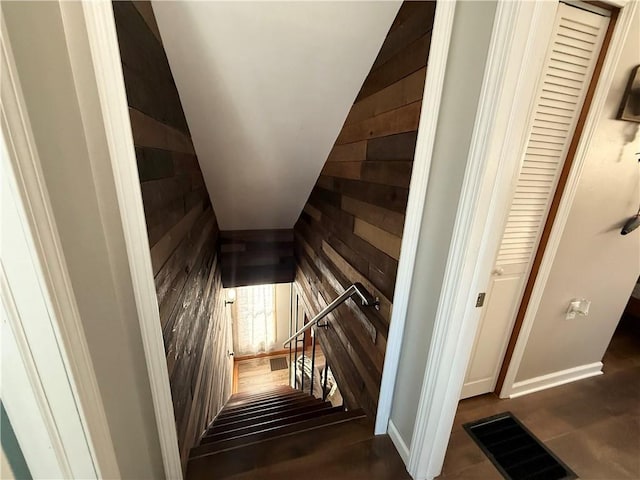 stairway with wood walls