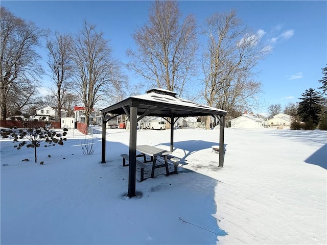 snowy yard with a gazebo