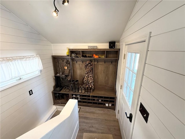 mudroom with lofted ceiling, wood walls, and dark hardwood / wood-style floors