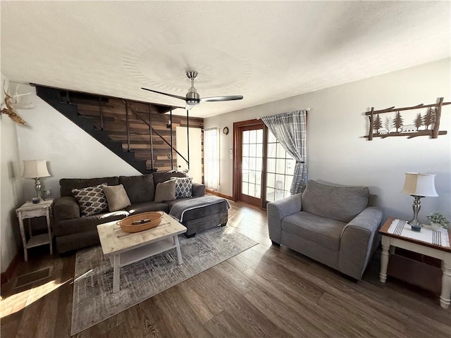 living room featuring ceiling fan, dark hardwood / wood-style floors, and a textured ceiling