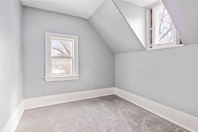 additional living space featuring vaulted ceiling, carpet floors, and baseboards