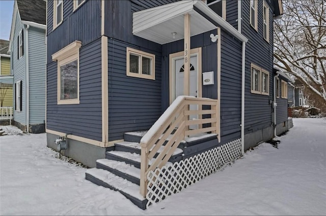 view of snow covered property entrance