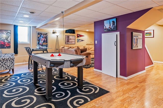 rec room featuring hardwood / wood-style flooring and a drop ceiling