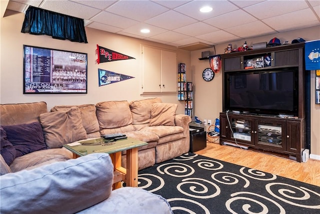 living room with light wood-type flooring and a drop ceiling