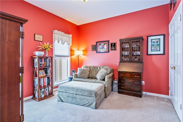 sitting room featuring light carpet