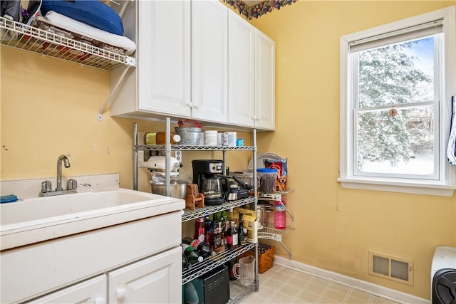 laundry area with sink and a healthy amount of sunlight