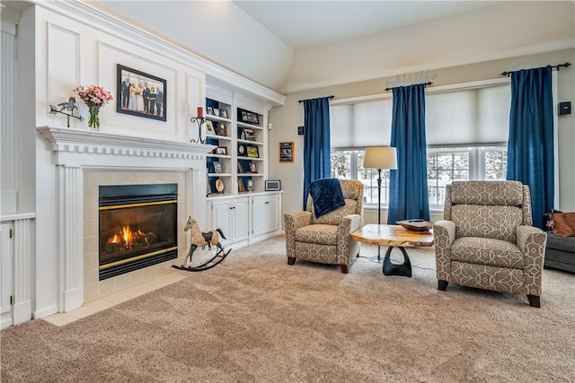 sitting room featuring a fireplace, light colored carpet, and built in features