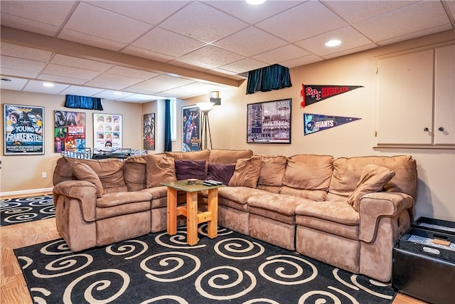 living room featuring hardwood / wood-style floors and a drop ceiling