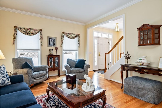 living room with light wood-type flooring and crown molding