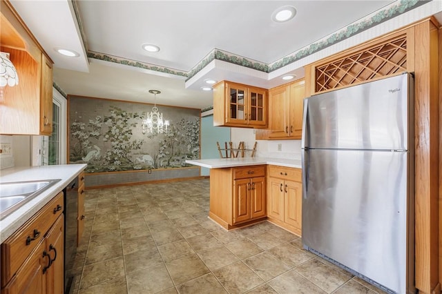 kitchen featuring kitchen peninsula, stainless steel appliances, a notable chandelier, and decorative light fixtures