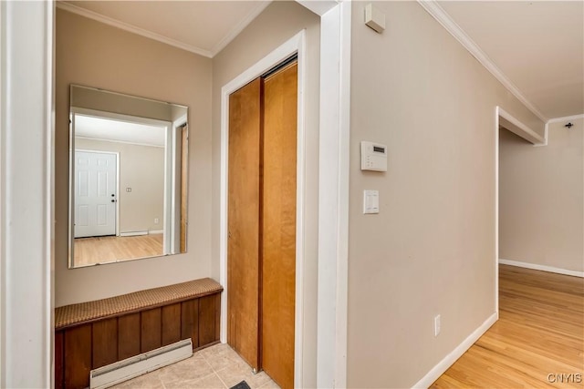 hall with baseboard heating, crown molding, and light hardwood / wood-style flooring