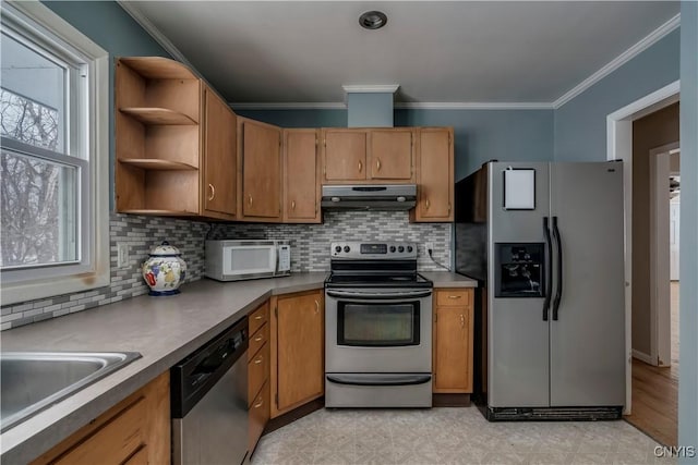 kitchen with appliances with stainless steel finishes, ornamental molding, and tasteful backsplash