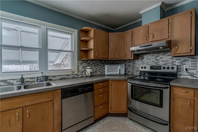 kitchen featuring sink, appliances with stainless steel finishes, crown molding, and decorative backsplash