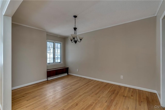 empty room with an inviting chandelier, light hardwood / wood-style floors, baseboard heating, and crown molding