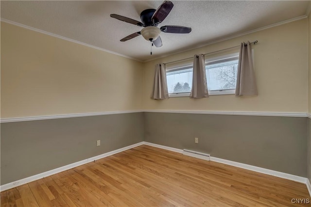 spare room featuring ceiling fan, light wood-type flooring, crown molding, and a textured ceiling