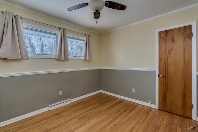 unfurnished bedroom with light wood-type flooring, a textured ceiling, ceiling fan, baseboard heating, and ornamental molding