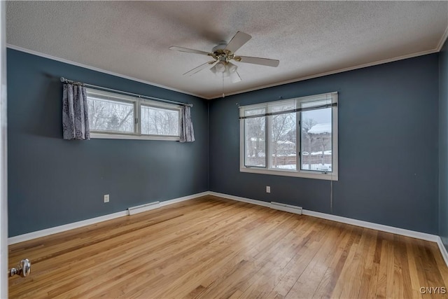 unfurnished room featuring a baseboard radiator, light hardwood / wood-style floors, ornamental molding, ceiling fan, and a textured ceiling