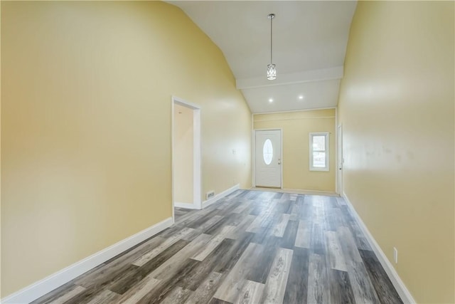 foyer entrance featuring high vaulted ceiling, baseboards, and wood finished floors