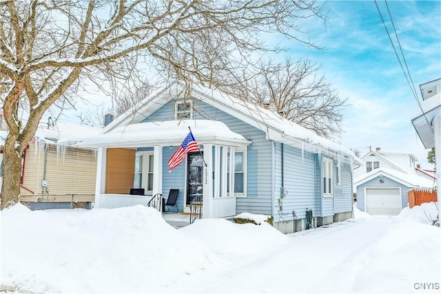 bungalow-style house with an outbuilding, a garage, and covered porch