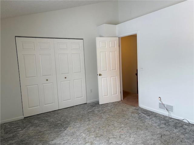 unfurnished bedroom featuring a closet and carpet flooring